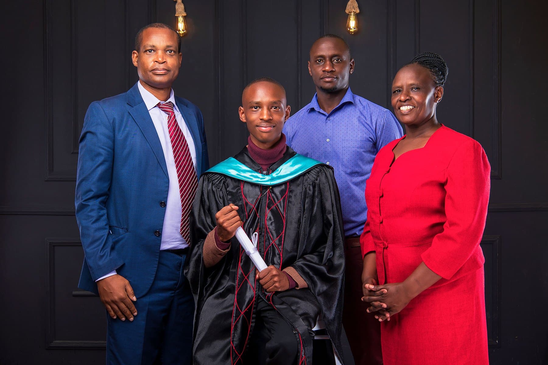 A family celebrating together as their son graduates in cap and gown